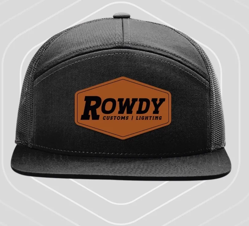Black seven-panel cap with charcoal mesh side panels and a leather Rowdy Customs patch.